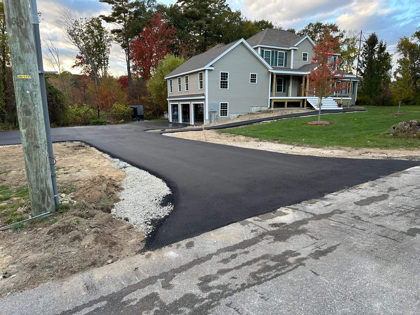 Compactor finishing a driveway