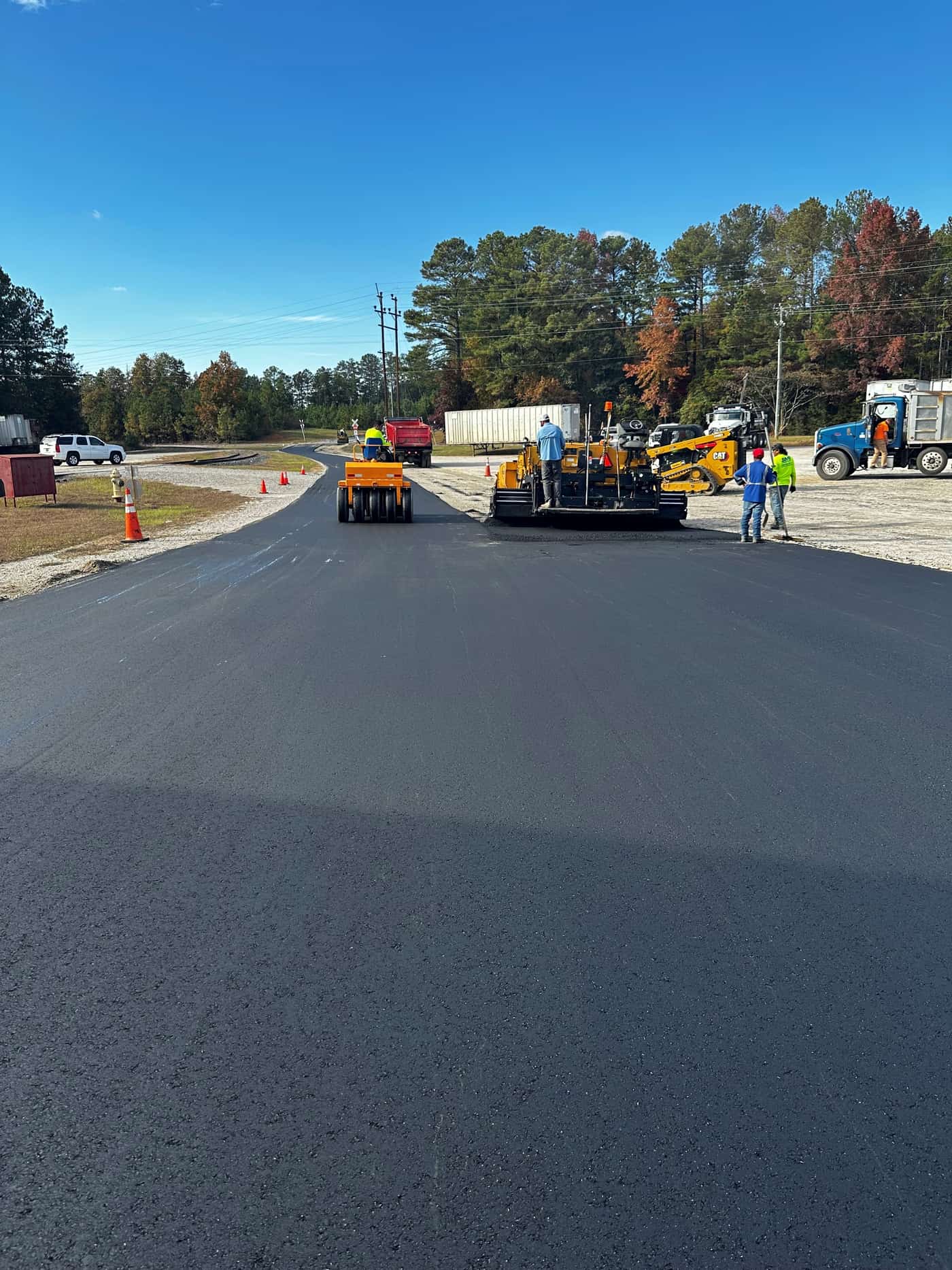 Fresh asphalt being laid on an Arkansas paving job